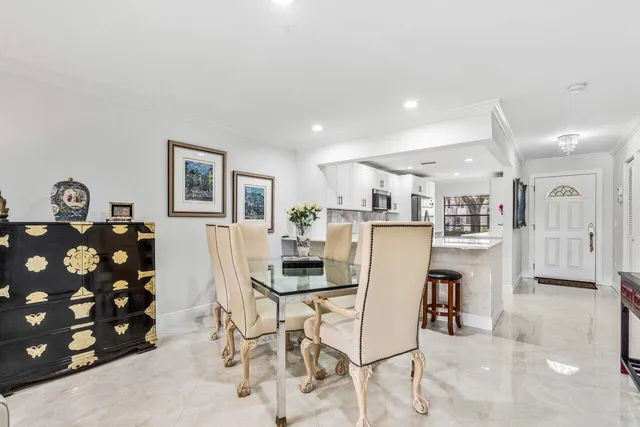 a kitchen with stainless steel appliances kitchen island granite countertop a refrigerator and cabinets