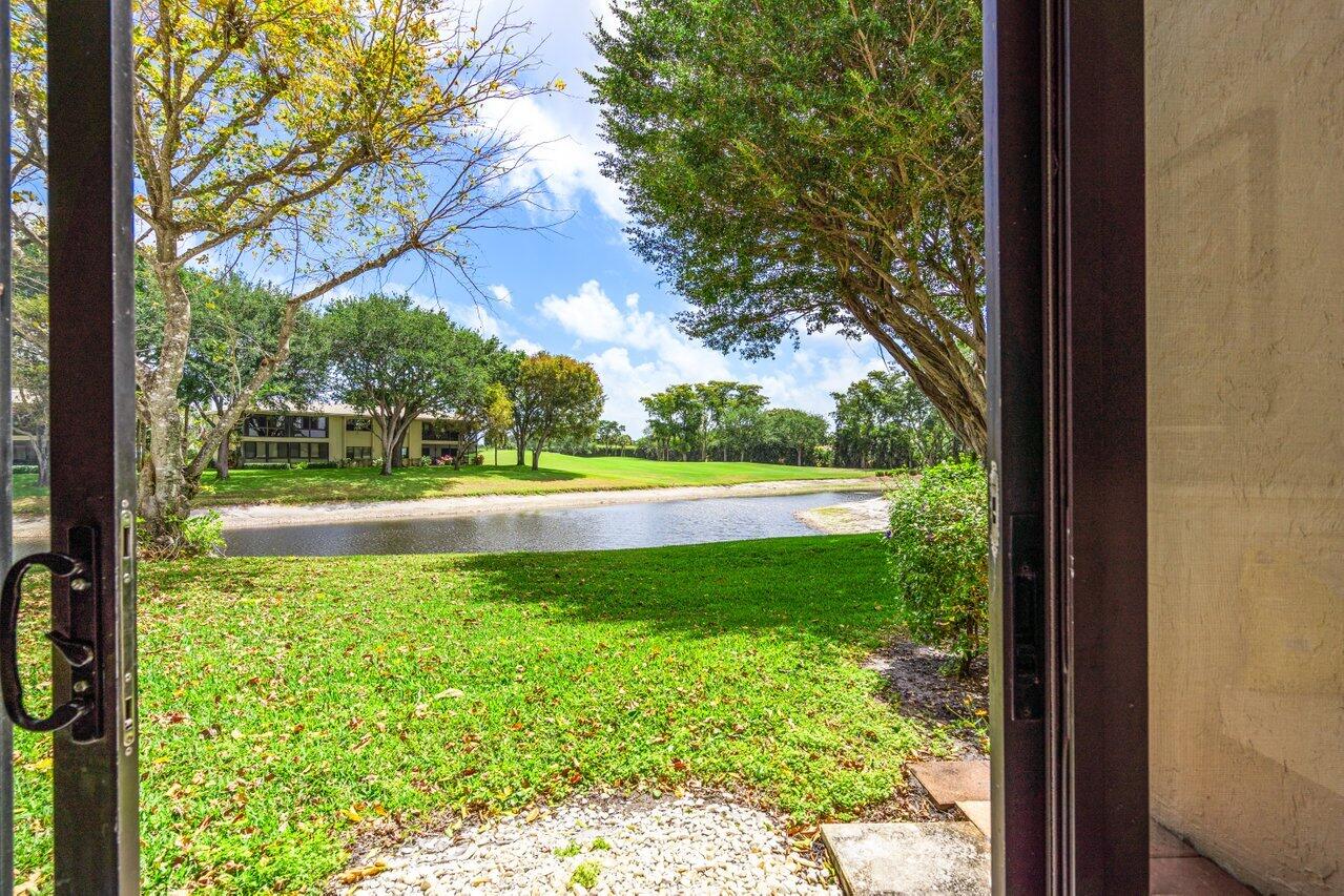 34 Stratford Lane West, Unit C Boynton Beach, FL 33436 - Photo 31 of 38 a view of swimming pool from a window