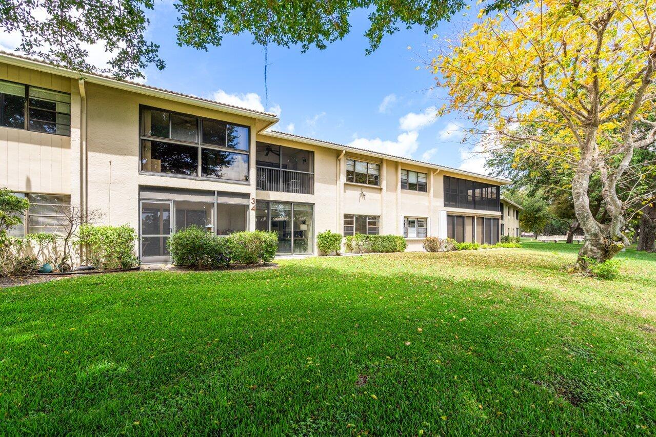 34 Stratford Lane West, Unit C Boynton Beach, FL 33436 - Photo 34 of 38 a front view of a house with a yard