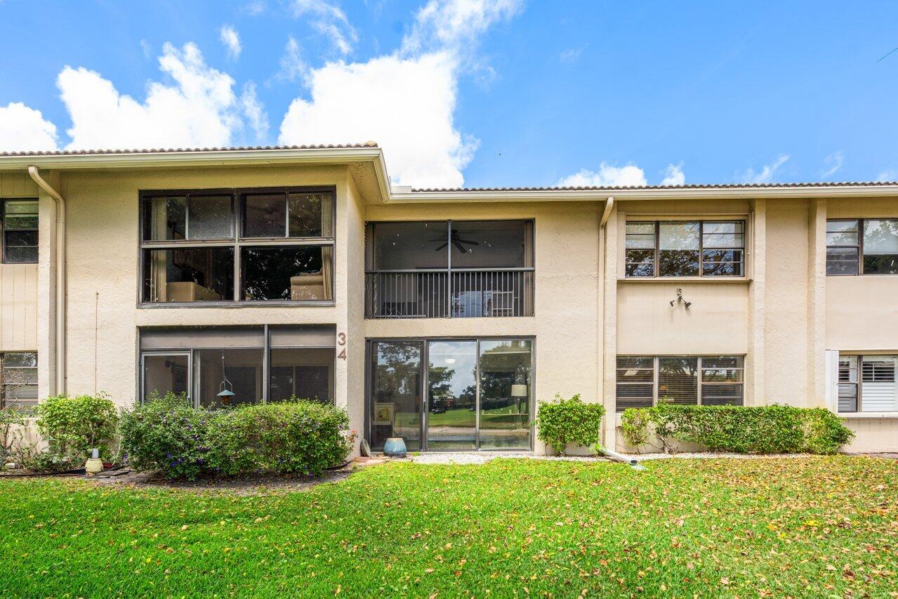 34 Stratford Lane West, Unit C Boynton Beach, FL 33436 - Photo 35 of 38 a front view of a house with a yard