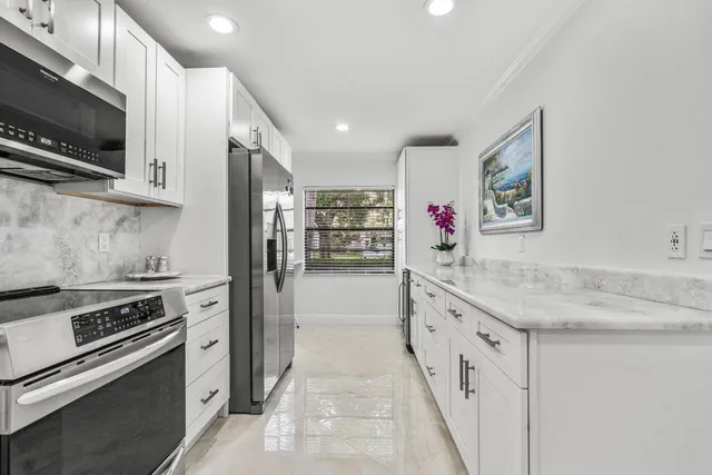 a kitchen with stainless steel appliances granite countertop a stove and a sink