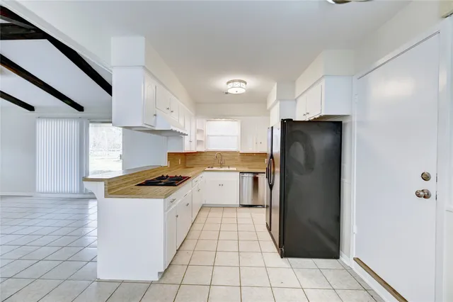 a kitchen with a stove a refrigerator and a sink