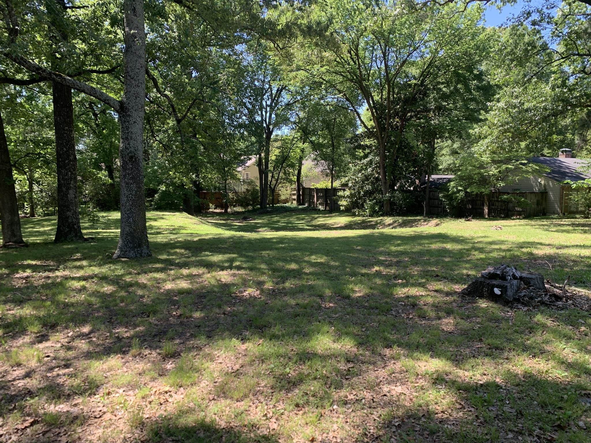 901 South Perkins Road Memphis, TN 38117 - Photo 6 of 13 a backyard of a house with a yard and large trees