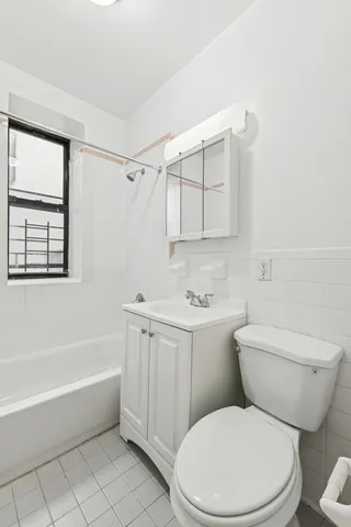 a bathroom with a toilet a sink and bathtub