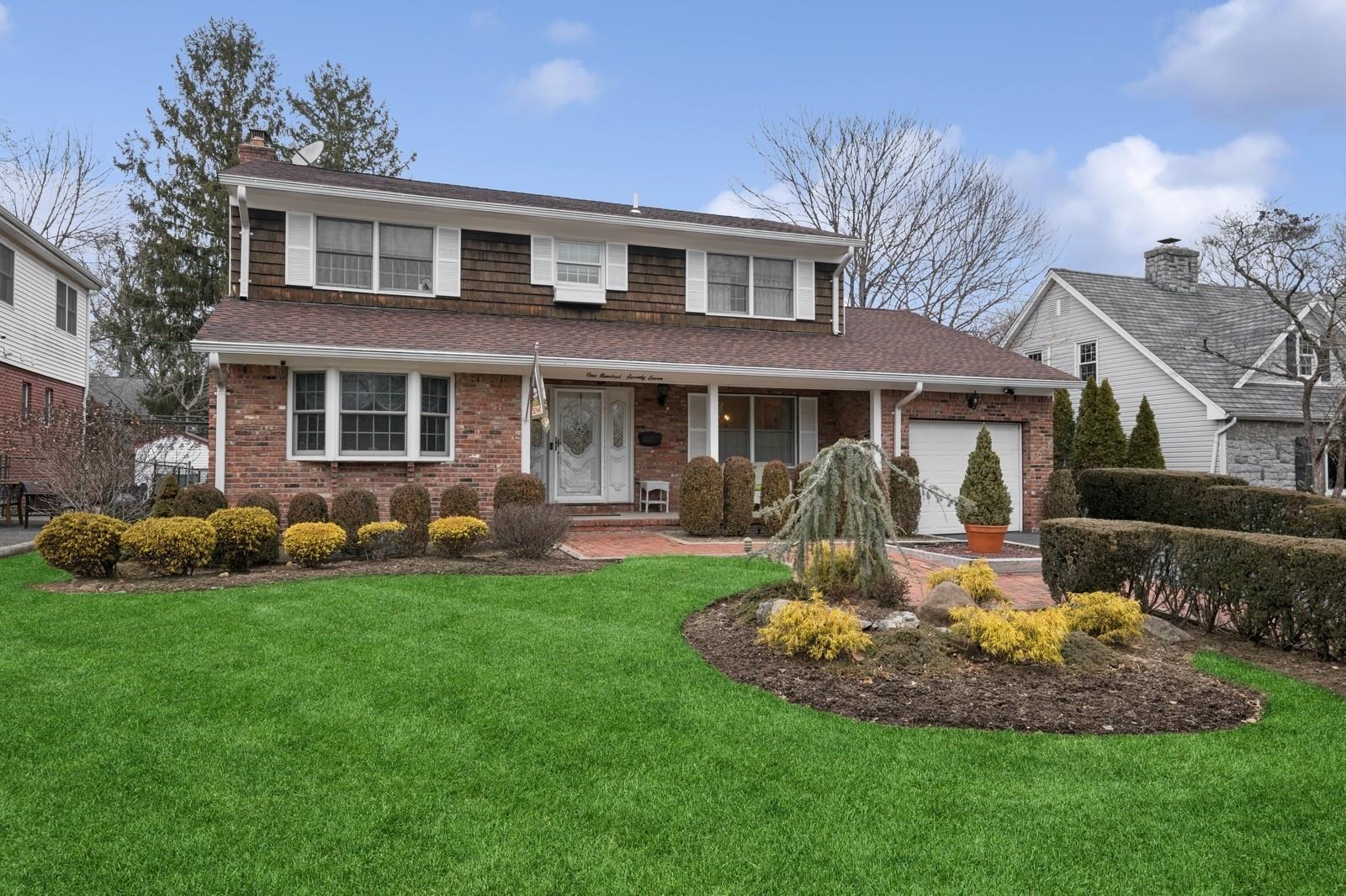 177 North Bourndale Road Manhasset, NY 11030 - Photo 1 of 1 a front view of a house with a yard and porch