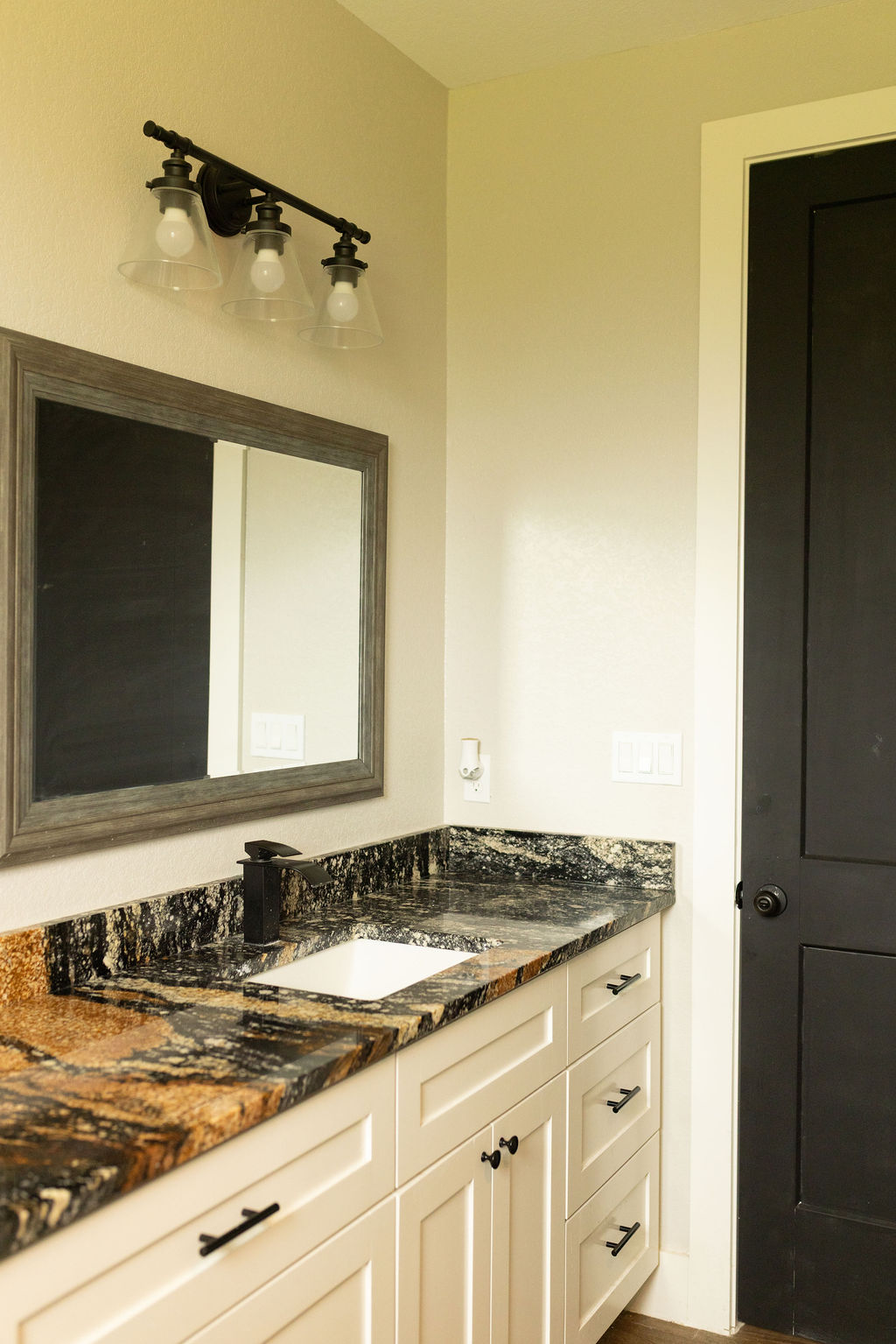 111 Powder Ridge Luling, TX 78648 - Photo 6 of 22 Bold granite countertops complement white cabinetry in this well-appointed bathroom.