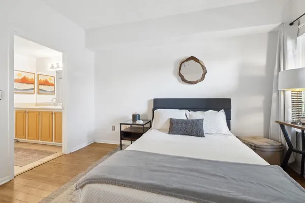 a bedroom with a bed and wooden floor