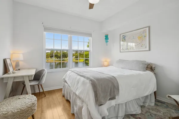 a bedroom with a bed a table and chair