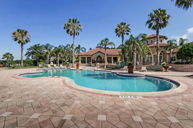 a view of a swimming pool with a table and chairs