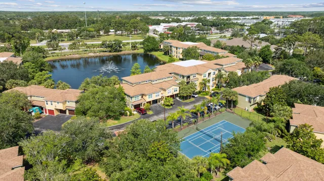 an aerial view of residential houses with outdoor space and lake view