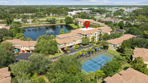 an aerial view of residential houses with outdoor space and swimming pool