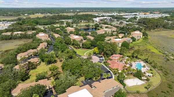 an aerial view of residential houses with outdoor space and trees