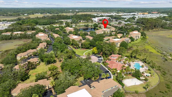 an aerial view of residential houses with outdoor space and river