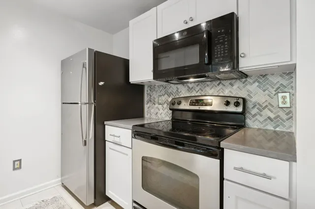 a kitchen with stainless steel appliances wooden cabinets and stove