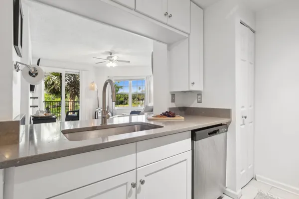 a kitchen with a sink and large window