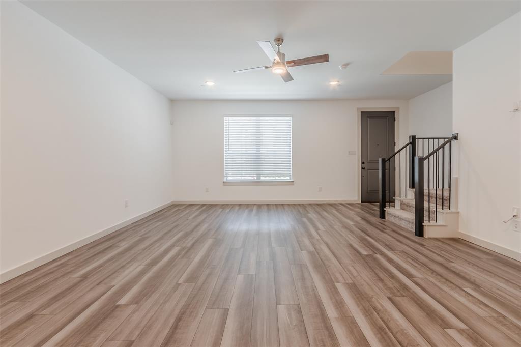 682 Vista Oaks Road Lewisville, TX 75067 - Photo 12 of 38 wooden floor in an empty room with a window