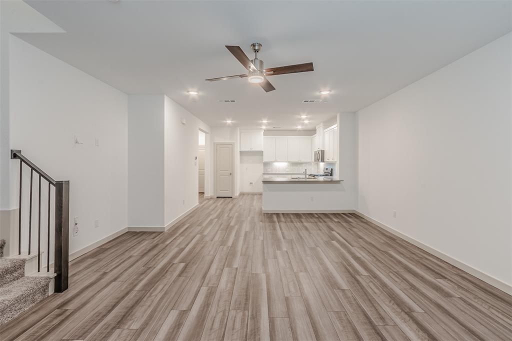 682 Vista Oaks Road Lewisville, TX 75067 - Photo 14 of 38 a view of a kitchen with a sink and wooden floor