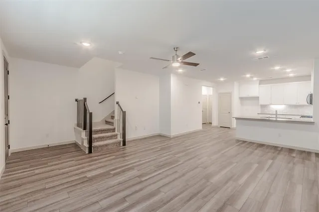 a view of a kitchen with a sink and wooden floor