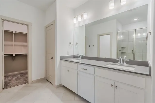 a spacious bathroom with a granite countertop sink mirror and shower