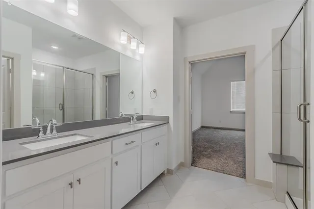 a bathroom with double sink and a mirror