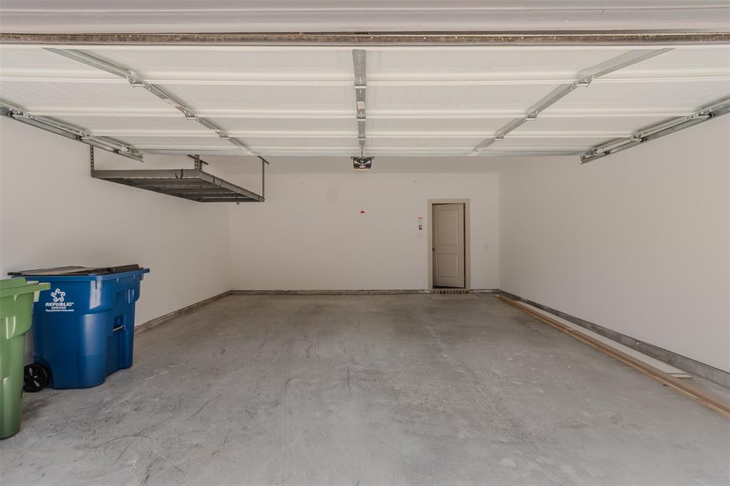 682 Vista Oaks Road Lewisville, TX 75067 - Photo 30 of 38 a view of a room with racks on the wall