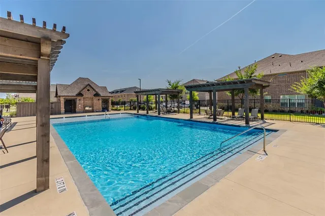 a swimming pool with outdoor seating and yard