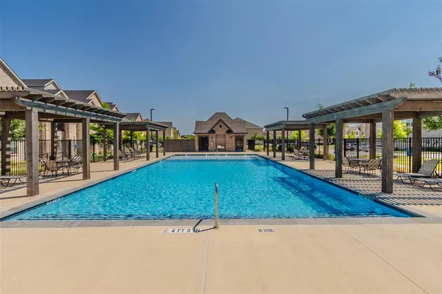 a view of swimming pool with a lounge chairs