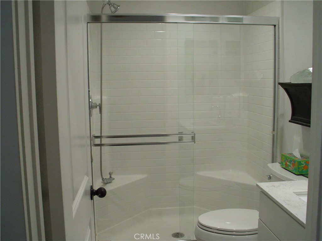 27393 Red Rock Road Moreno Valley, CA 92555 - Photo 8 of 31 a bathroom with a shower a bathtub and a toilet