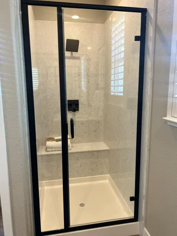 a bathroom with a glass shower door