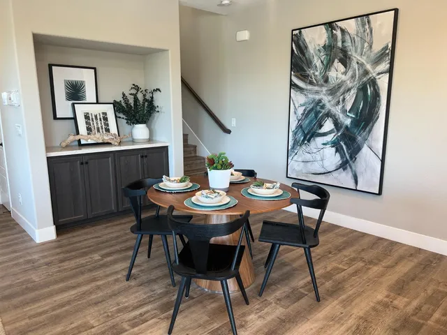 a view of a dining room with furniture and wooden floor