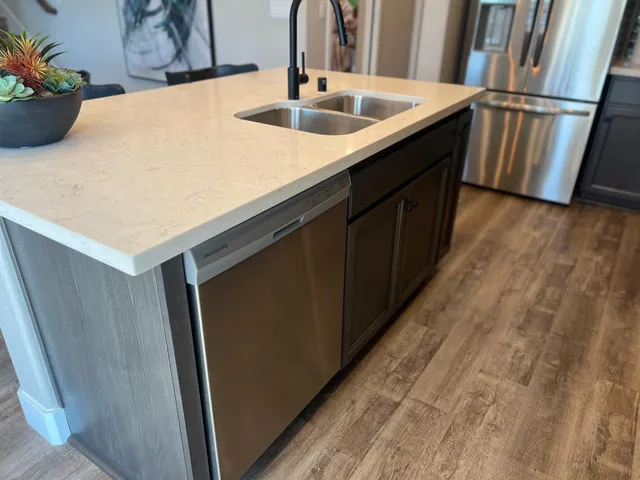 a kitchen with a sink and a refrigerator