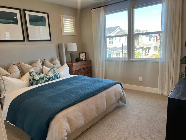 a bedroom with a bed and window