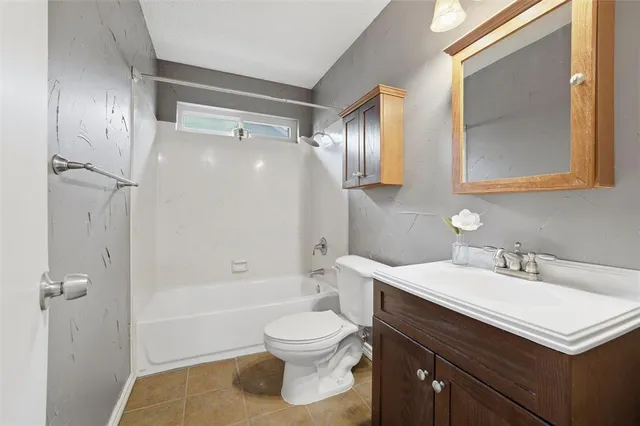 a bathroom with a sink toilet tub and shower