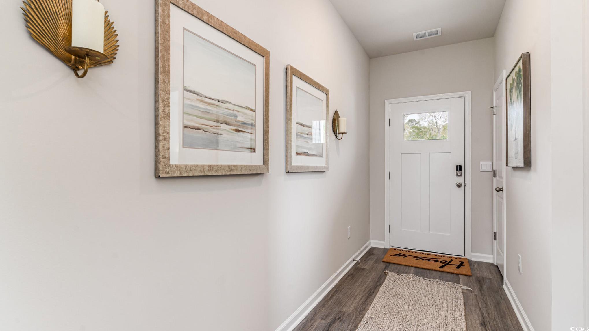 857 Farmers Passage Loop Loris, SC 29569 - Photo 2 of 25 Entryway with dark wood-style flooring and baseboards