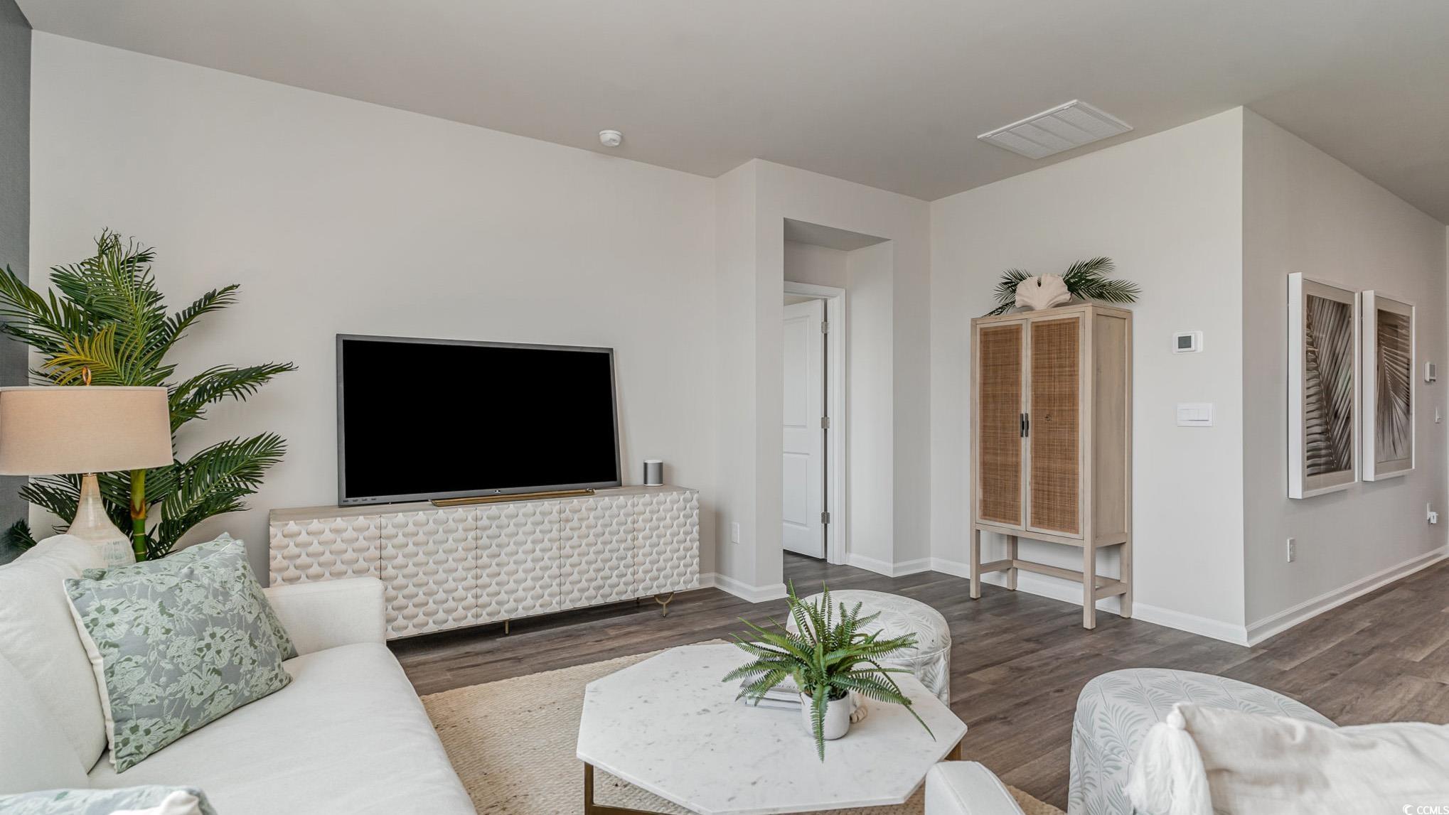 857 Farmers Passage Loop Loris, SC 29569 - Photo 6 of 25 Living area featuring wood finished floors and baseboards