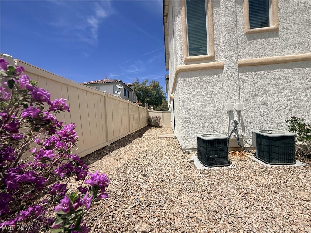 11953 Fairfax Ridge Street Las Vegas, NV 89183 - Photo 30 of 32 A private side yard with easy-care gravel, perfect for low-maintenance outdoor living.