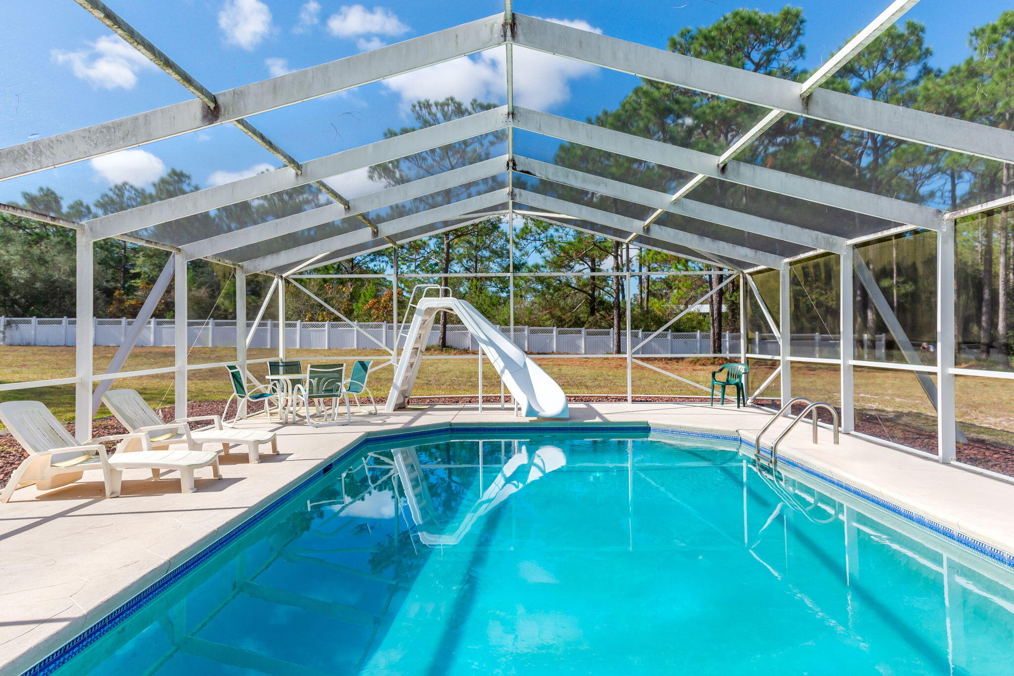 9524 Bone Bluff Drive Navarre, FL 32566 - Photo 13 of 68 a view of a house with a swimming pool
