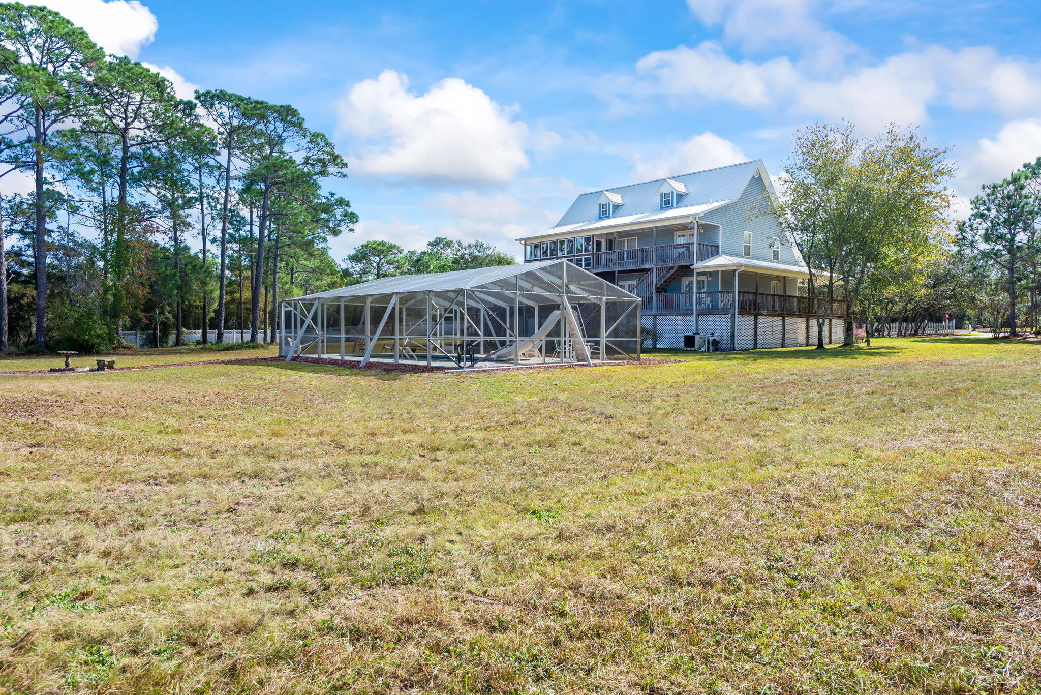 9524 Bone Bluff Drive Navarre, FL 32566 - Photo 16 of 68 a view of a house with swimming pool and sitting area