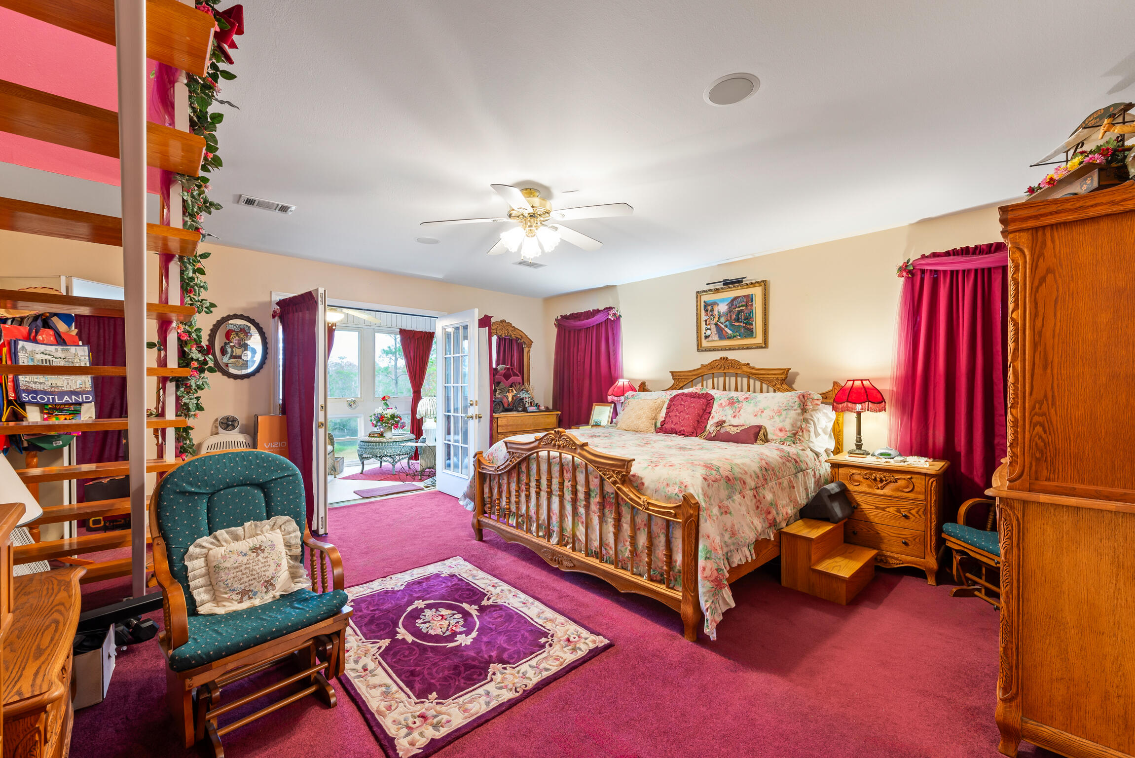 9524 Bone Bluff Drive Navarre, FL 32566 - Photo 37 of 68 a bedroom with a bed and a chandelier