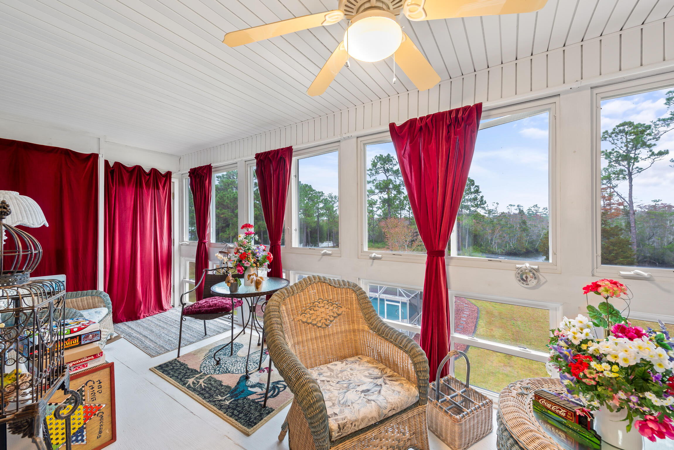 9524 Bone Bluff Drive Navarre, FL 32566 - Photo 40 of 68 a living room with furniture a flat screen tv and a large window