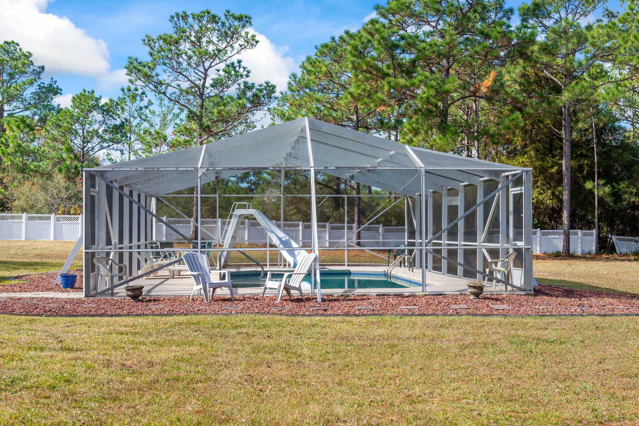 9524 Bone Bluff Drive Navarre, FL 32566 - Photo 4 of 68 a view of a swimming pool with a sitting space