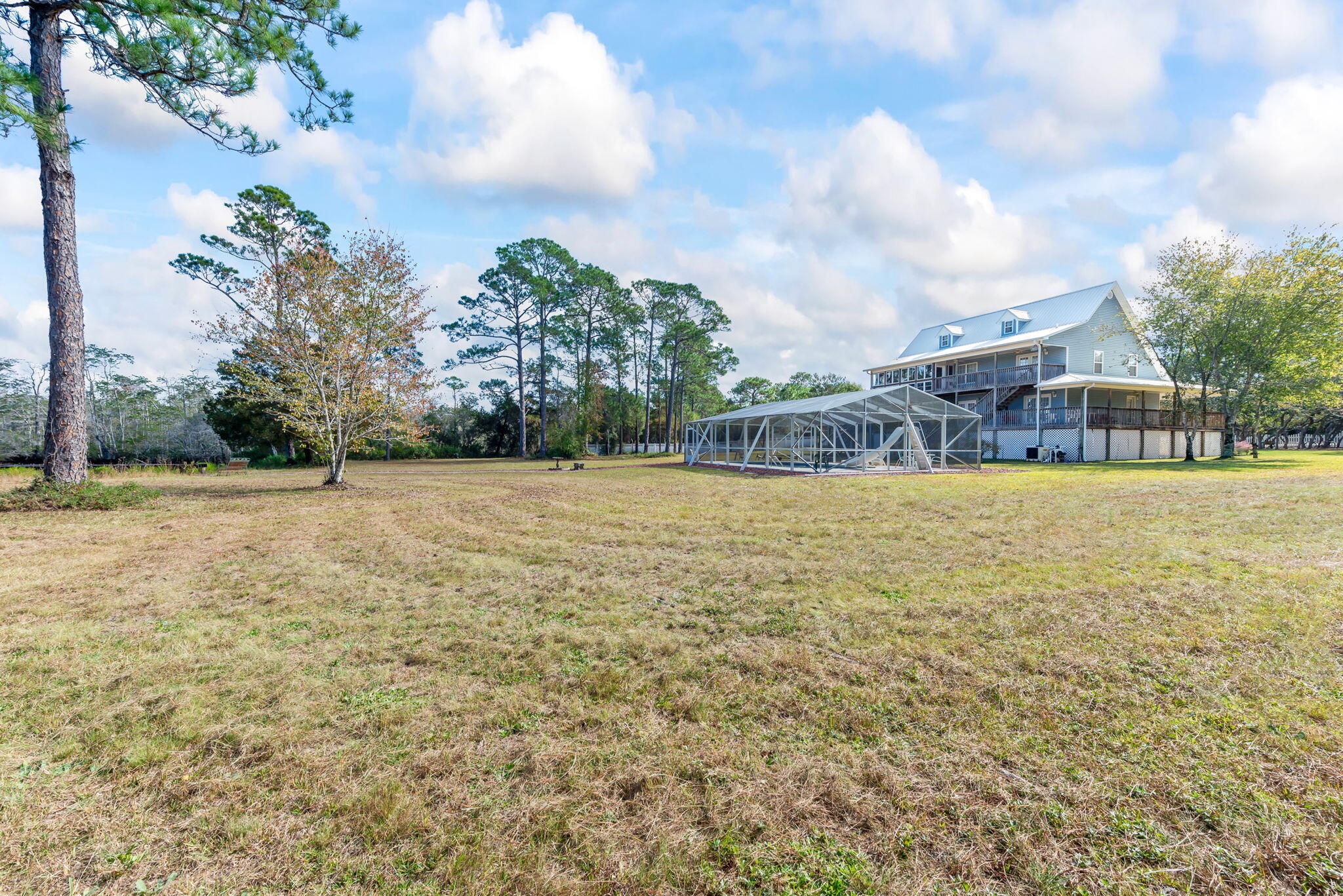 9524 Bone Bluff Drive Navarre, FL 32566 - Photo 59 of 68 a view of swimming pool with lawn chairs and plants
