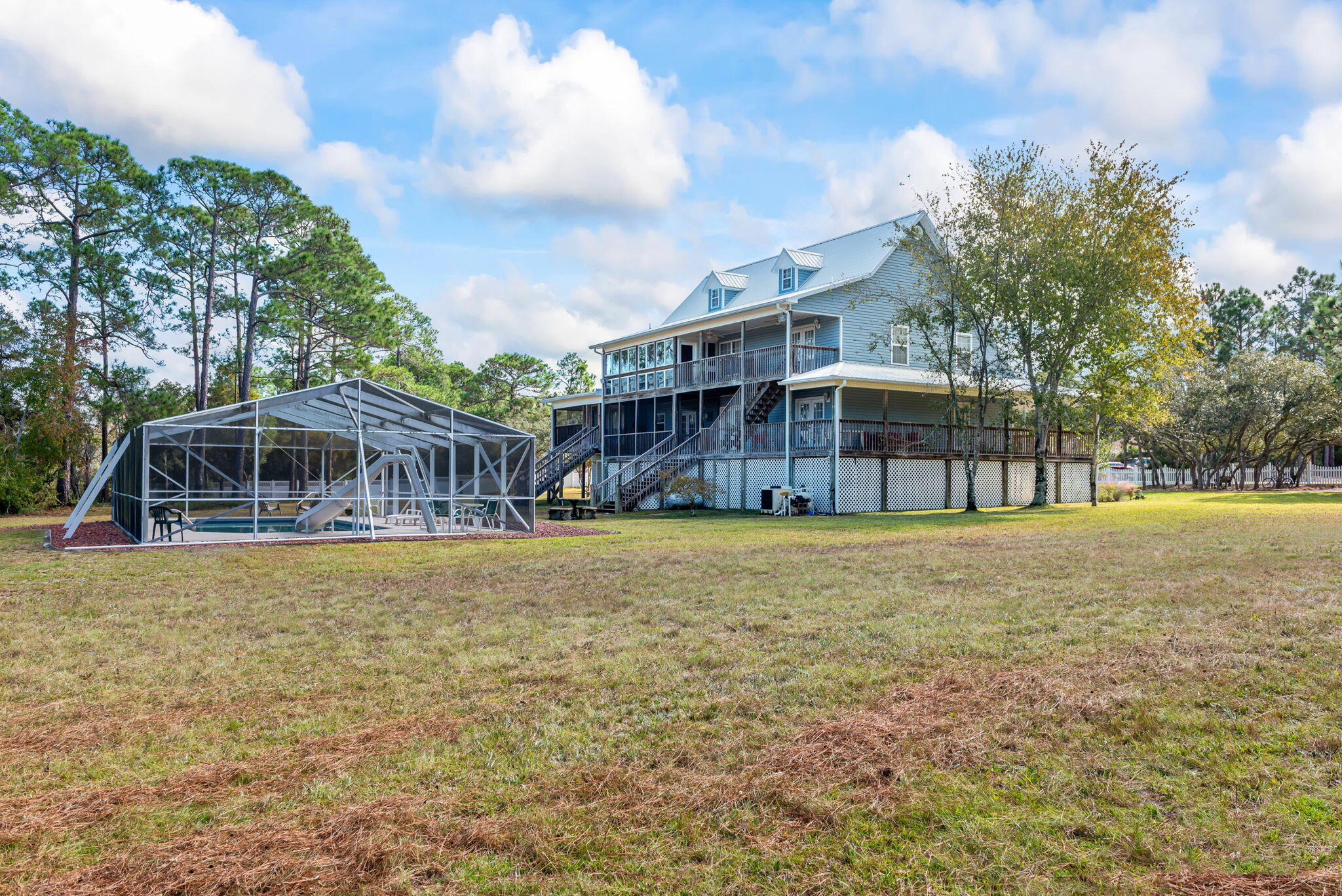 9524 Bone Bluff Drive Navarre, FL 32566 - Photo 61 of 68 a view of a house with a yard