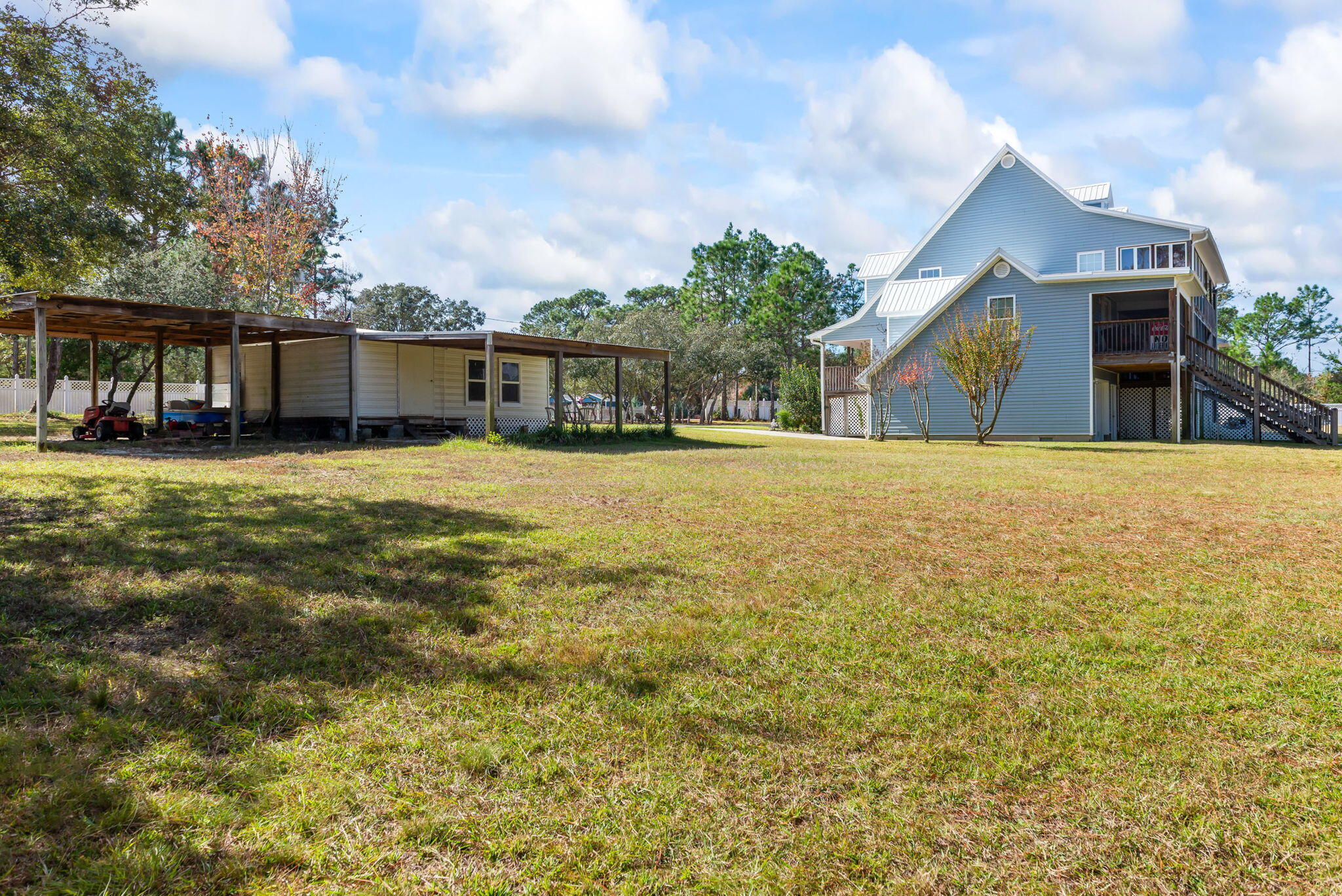 9524 Bone Bluff Drive Navarre, FL 32566 - Photo 65 of 68 a view of a house with a yard and garage