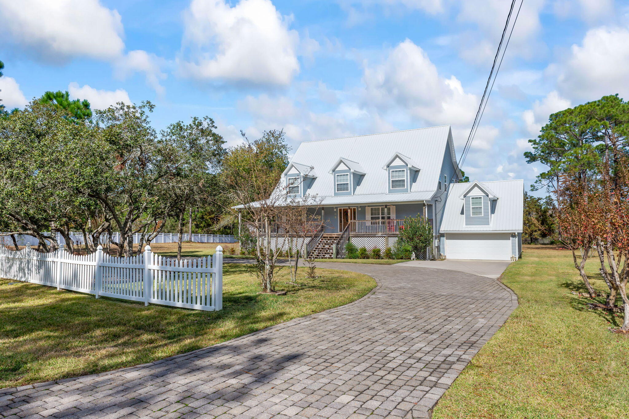 9524 Bone Bluff Drive Navarre, FL 32566 - Photo 7 of 68 a front view of a house with garden