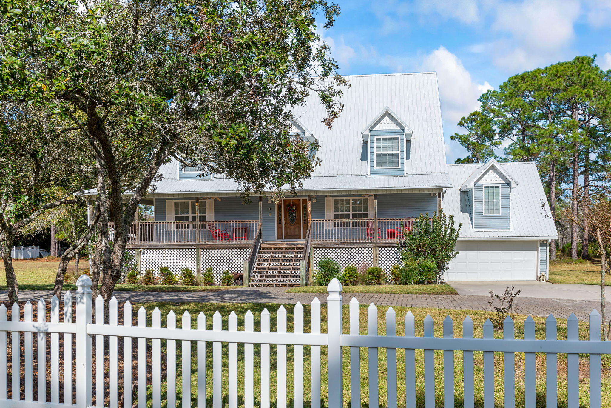 9524 Bone Bluff Drive Navarre, FL 32566 - Photo 8 of 68 a front view of a house with a garden