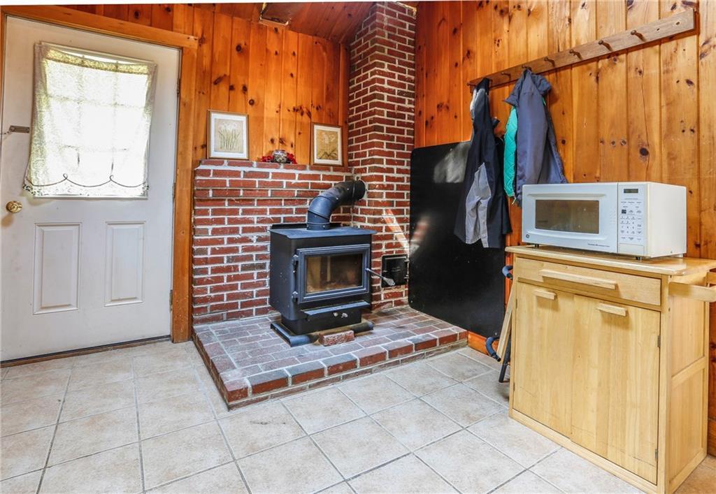 443 Curtis Road Swanville, ME 04915 - Photo 8 of 35 Kitchen with woodstove and door to...