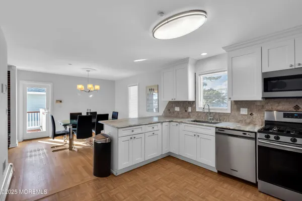 a kitchen with a sink stove top oven and microwave