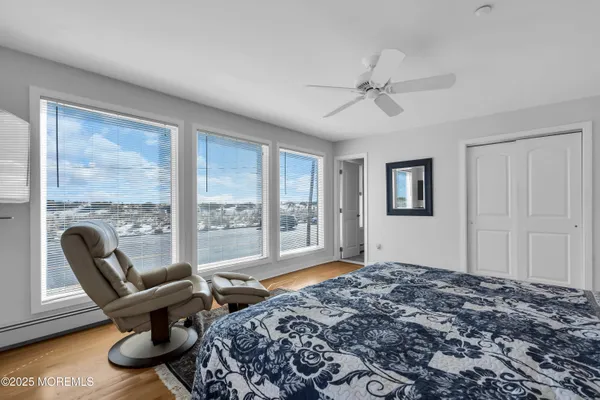 a bedroom with a bed and a flat tv screen on dresser