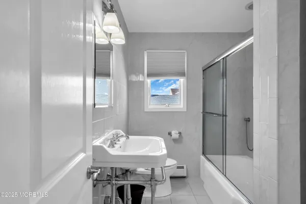 a bathroom with a toilet a sink and a mirror